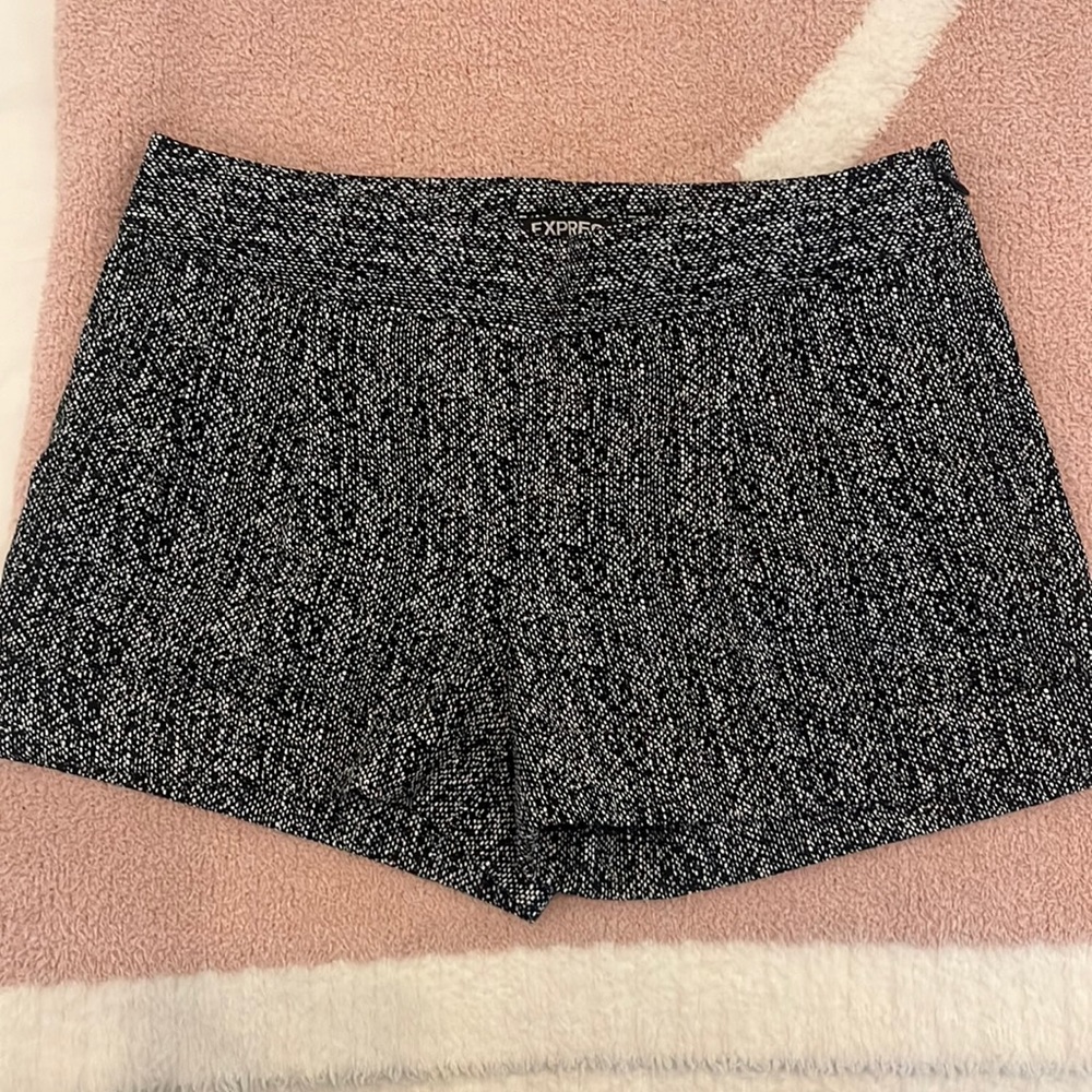 Express black and white polyester zip up shorts with cuffs and pockets.